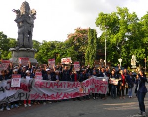 Presiden BEM UNUD (paling kanan) memimpin aksi mahasiswa di perempatan Catur Muka, Denpasar (24/3)